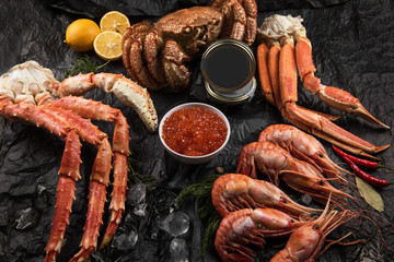 Set of seafood: red and black caviar, limb of hairy crab, limb of snow crab, far eastern kamchatka crab