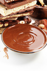 Chocolate bars on table with chocolate tower.