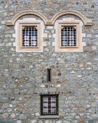 Fototapeta na wymiar Picture of old vintage concrete wall with windows placed like face