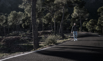 Fototapeta na wymiar young man walking on the road