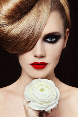 Portrait of young beautiful woman with smoky eye make-up and prom hairdo © Olga Ekaterincheva