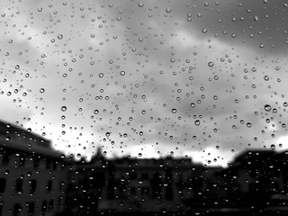 Genova, Italy - 10/28/2018: An amazing photography of some waterdrops over the window after summer rain in the city