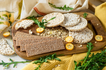 Round crispy rice crackers and Rye Crackers whith kumquat. Dietary concept and healthy vegetarian food. 