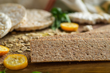 Round crispy rice crackers and Rye Crackers whith kumquat. Dietary concept and healthy vegetarian food. 