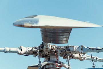 The blades of a helicopter against the sky.