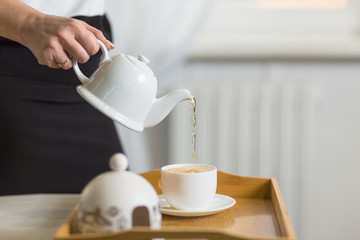 Fototapeta na wymiar female pouring tea