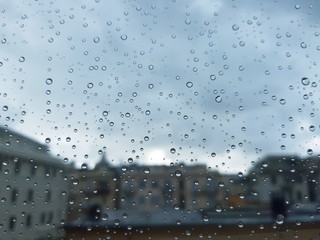 Naklejka na ściany i meble Genova, Italy - 10/28/2018: An amazing photography of some waterdrops over the window after summer rain in the city