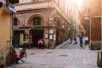 Fototapeta na wymiar Old narrow street in Bologna, Emilia Romagna, Italy