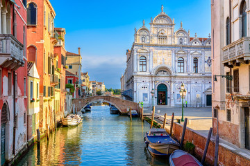 Narrow canal with bridge in Venice, Italy. Architecture and landmark of Venice. Cozy cityscape of Venice.