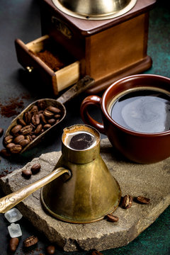 Vintage coffee pot and mill on dark grunge background