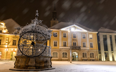 Iron well and city hall of Bruck an der Mur, Austria