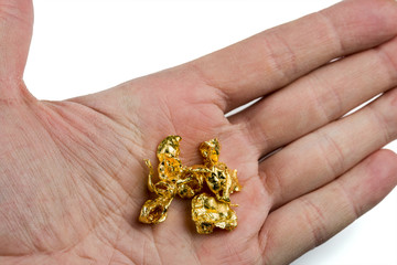 A few gold nuggets on the male palm. Isolated on white background.