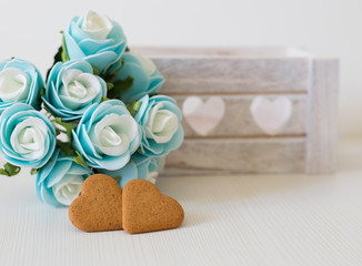 blue roses and heart shapes cookies for valentine and mother day background with space to write