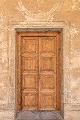 Fototapeta na wymiar Classic solid wood door in one of the buildings of the Alhambra, Granada