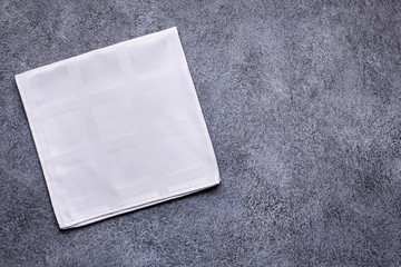 White napkin on gray concrete background top view with copy space