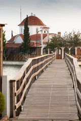 Fototapeta na wymiar Wooden bridge in Saint Nicholas monastery in Porto Lagos, Xanthi, Greece