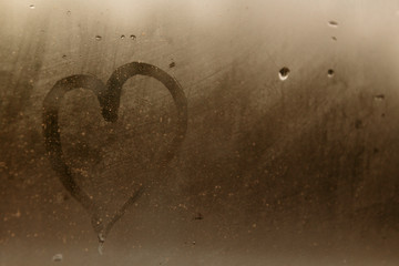Heart drawing on a foggy window. Concept of declaration of love.