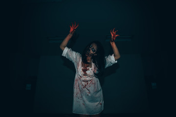Portrait of asian woman make up ghost face with blood,Horror scene,Scary background,Halloween...