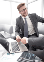 close up. smiling lawyer gives his business card to businessman