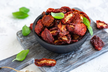 Sun-dried tomatoes in an old wooden bowl.