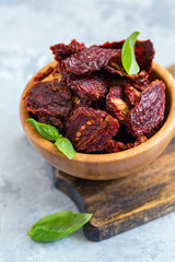 Homemade sun-dried tomatoes and basil in a bowl.