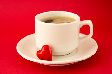 Cup of coffee isolated on red background. View from above. Web design, poster, invitation card. Valentine's Day concept.