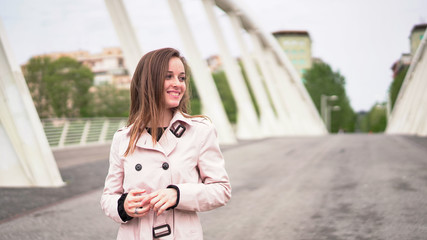 Fototapeta premium European girl having holidays in Rome, Italy. Attractive woman with beautiful smile and adorable eyes posing on the Roman bridge. Italian fashion 