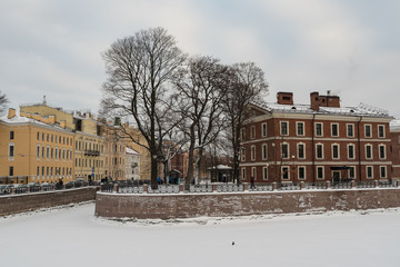 Fototapeta na wymiar Island New Holland with river Moyka covered by snow and ice, St. Petersburg, Russia