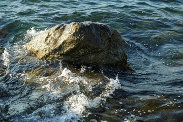 Rocks seen from the water into the sea and the waves.
