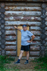 Male tourist at the wooden fortress on excursions.