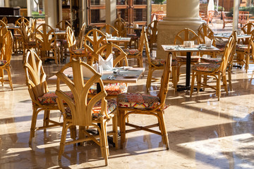 set  tables for breakfast in the hotel restaurant