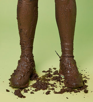 Close up of boy's legs covered with mud