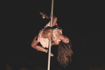 Woman practicing pole dance