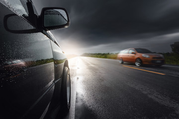 Black compact SUV car with storm clouds as background,transportation during bad weather condition...