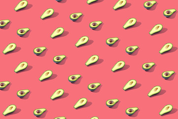 Many halves of avocado, pattern, banner. The procurement of bright background, red coral pastel color.