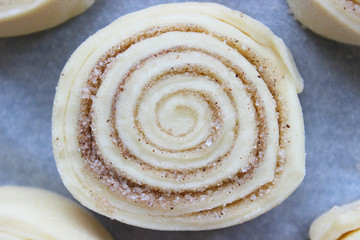Beautiful fresh cinnamon rolls. The cooking process. Fresh fragrant pastries. Raw dough for buns.Close up.