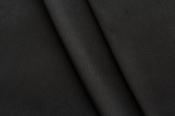 black fabric with two large diagonal folds