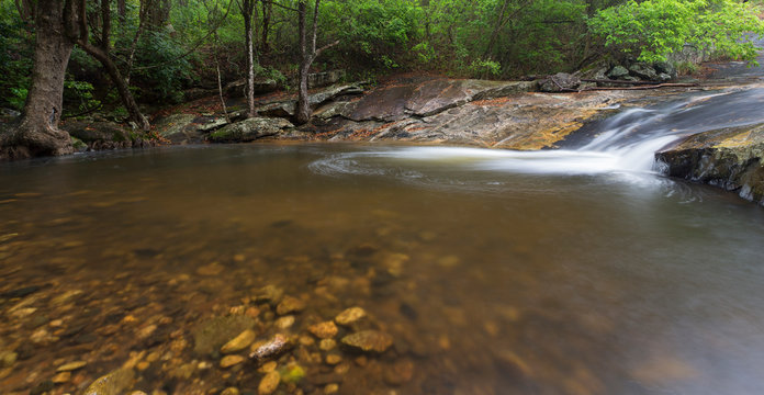 River flowing over rocks and the Debengeni Waterfall