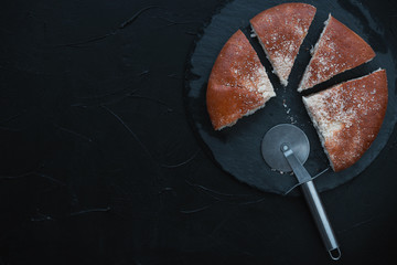 Fresh baked bread sliced into pieces on black background.Top view.percentage concept