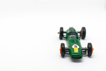 Fototapeta premium Miniature green race car with number 3 isolated on a white background for on a three-year-old birthday cart