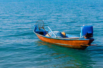 Thai fishing boat on the waves of the azure sea.
