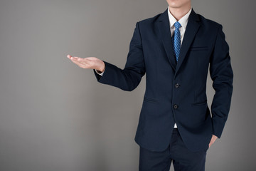 Close up Business man is holding something , grey background in studio