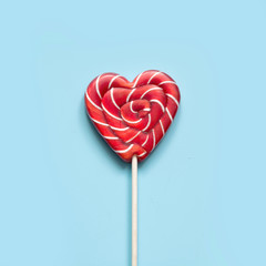 Valentine's card. Lollipops candy as heart on blue. Funny concept.