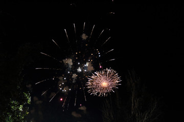 The sparkling and bright fireworks during the 2017 Pilar festival against a dark sky in Zaragoza, Aragon region, Spain