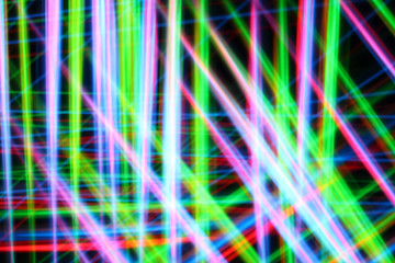A colorful and glowing light painting abstract image with red, green, blue and yellow blurry lines over a black background, creating a net