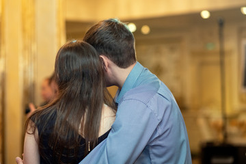 A man embracing a woman. Couple in love, hugging.