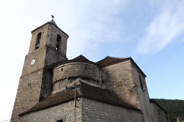 Fototapeta na wymiar The stone made, modern Saint Martin's church (Iglesia de San Martin) and its bell tower with clock in the rural village of Hecho, Aragon, Spain