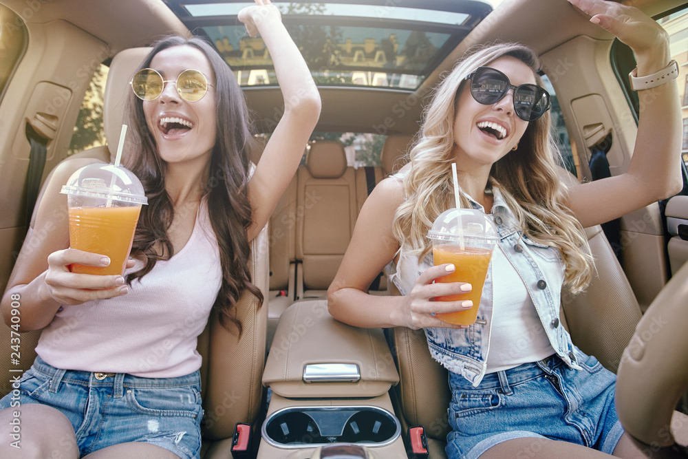 Poster women holding cocktails in plastic cups