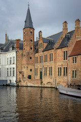 Fototapeta na wymiar BRUGES, BELGIUM – January 3, 2019: Canals, roofs and facades of the city which was proclaimed as a historical heritage