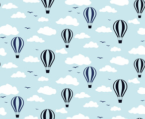 Seamless pattern of balloons in the clouds against the blue sky.